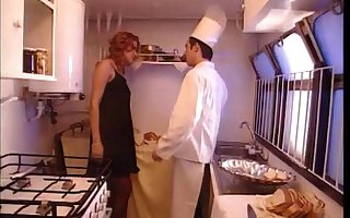 Retro porn video with a brunette wife being fucked in the kitchen